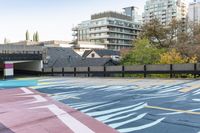 colorful parking space in front of tall buildings and apartment complex in urban area area with skateboarder