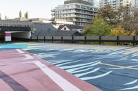 colorful parking space in front of tall buildings and apartment complex in urban area area with skateboarder