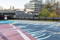 colorful parking space in front of tall buildings and apartment complex in urban area area with skateboarder