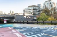 colorful parking space in front of tall buildings and apartment complex in urban area area with skateboarder