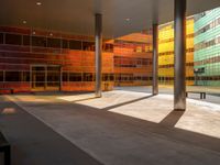 the large windows look very colorful from every angle outside the building and inside the building is concrete