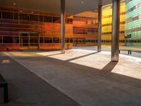 the large windows look very colorful from every angle outside the building and inside the building is concrete