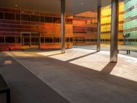 the large windows look very colorful from every angle outside the building and inside the building is concrete