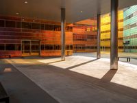 the large windows look very colorful from every angle outside the building and inside the building is concrete