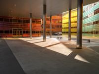 the large windows look very colorful from every angle outside the building and inside the building is concrete