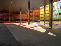 the large windows look very colorful from every angle outside the building and inside the building is concrete