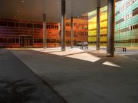 the large windows look very colorful from every angle outside the building and inside the building is concrete