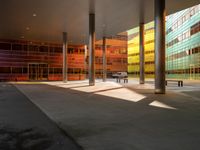 the large windows look very colorful from every angle outside the building and inside the building is concrete