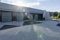 a view of an outside area of an office building with large windows and a circular driveway