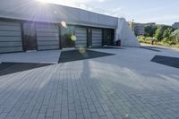 a view of an outside area of an office building with large windows and a circular driveway