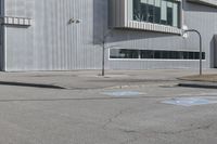 a red stop sign sitting in front of a building with parking spaces on both sides