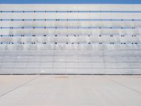 the concrete and seats are lined with lines and dots on the wall of the bleachers