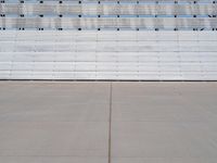 the concrete and seats are lined with lines and dots on the wall of the bleachers