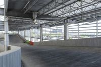 a skate boarder is riding down the edge of an empty ramp in a building