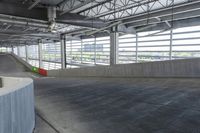 a skate boarder is riding down the edge of an empty ramp in a building