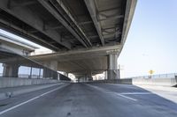 Concrete Bridge on Asphalt Road Under Clear Sky