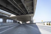 Concrete Bridge on Asphalt Road Under Clear Sky