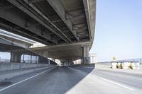 Concrete Bridge on Asphalt Road Under Clear Sky