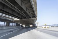 Concrete Bridge on Asphalt Road Under Clear Sky