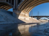 Concrete Bridge Underpass Overlooking the River with a Shadow