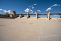 concrete building in desert with walkway and sky background, outside area of the structure with the concrete walls