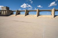 concrete building in desert with walkway and sky background, outside area of the structure with the concrete walls