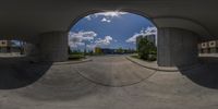 a view of the bottom of the concrete building from inside the cement circular panoramic shot