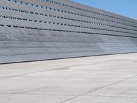 the building has vertical concrete walls and concrete floors to separate it from a long wall