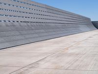 the building has vertical concrete walls and concrete floors to separate it from a long wall