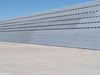 the building has vertical concrete walls and concrete floors to separate it from a long wall
