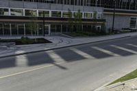 this is an image of a residential area with stop lights, trees, and concrete buildings