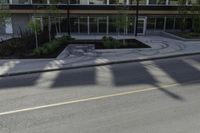 this is an image of a residential area with stop lights, trees, and concrete buildings