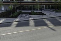 this is an image of a residential area with stop lights, trees, and concrete buildings