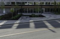 this is an image of a residential area with stop lights, trees, and concrete buildings