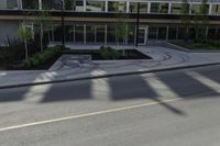 this is an image of a residential area with stop lights, trees, and concrete buildings