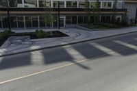 this is an image of a residential area with stop lights, trees, and concrete buildings