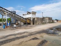 a view of the concrete factory from the road side with its equipment on display and next to the truck