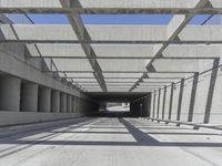 a long open road with many gray cement walls and pillars in the middle of the road