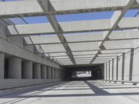 a long open road with many gray cement walls and pillars in the middle of the road