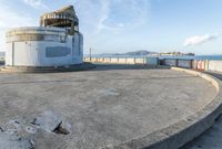 an old concrete observation tower stands in the middle of the city in the distance, overlooking the skyline