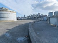 an old concrete observation tower stands in the middle of the city in the distance, overlooking the skyline