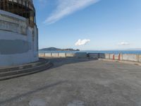 an old concrete observation tower stands in the middle of the city in the distance, overlooking the skyline