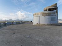 an old concrete observation tower stands in the middle of the city in the distance, overlooking the skyline