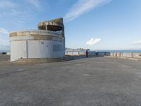 an old concrete observation tower stands in the middle of the city in the distance, overlooking the skyline