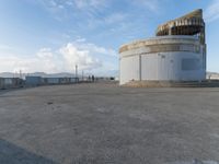 an old concrete observation tower stands in the middle of the city in the distance, overlooking the skyline