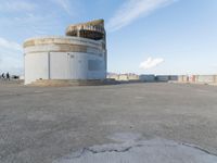 an old concrete observation tower stands in the middle of the city in the distance, overlooking the skyline