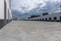 a parking garage has yellow lines on the ground of it and blue sky in the background