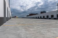 a parking garage has yellow lines on the ground of it and blue sky in the background