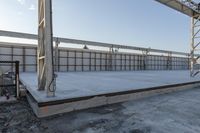 a large concrete platform under construction with sky background in a large area, outdoors,