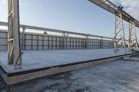 a large concrete platform under construction with sky background in a large area, outdoors,